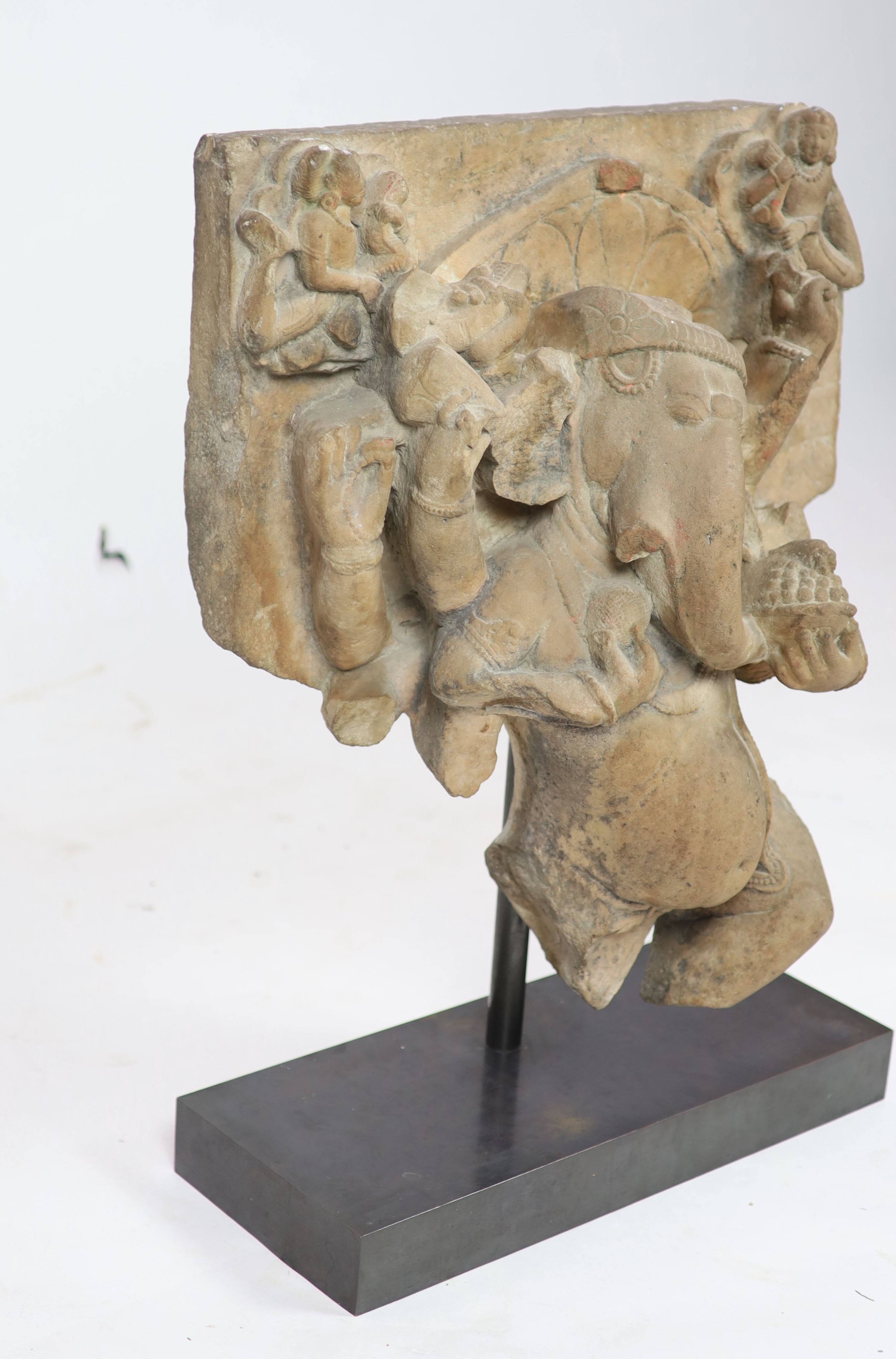 An Indian sandstone Ganesha stele fragment, Rajasthan 11th/12th century, 66cm high, 60 cm wide, excluding metal stand